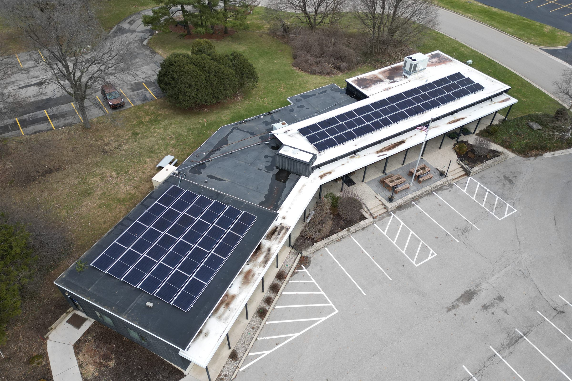 Rooftop solar arrays on both wings of a commercial building in West Michigan, installed by Augustine Solar