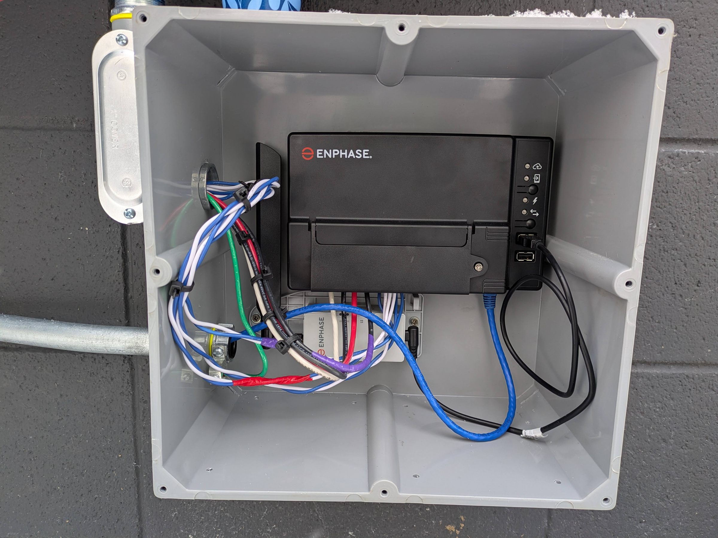 System monitoring gateway wired into a weatherproof enclosure, with every conductor labeled and dressed